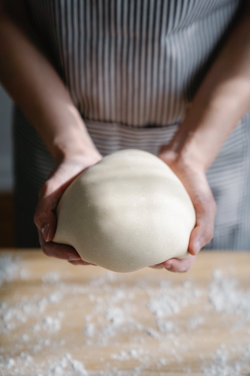 close up of person making dough